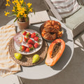 Soft summer flatlay, colorful bowl of fresh seasonal fruits and vegetables, warm golden light, linen texture, wellness lifestyle photography, earthy tones influence of seasonal  Variations  on your gut