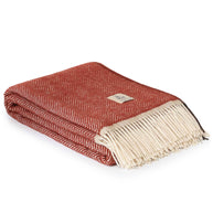 rode wollen plaid opgevouwen met franjes en zigzagpatroon