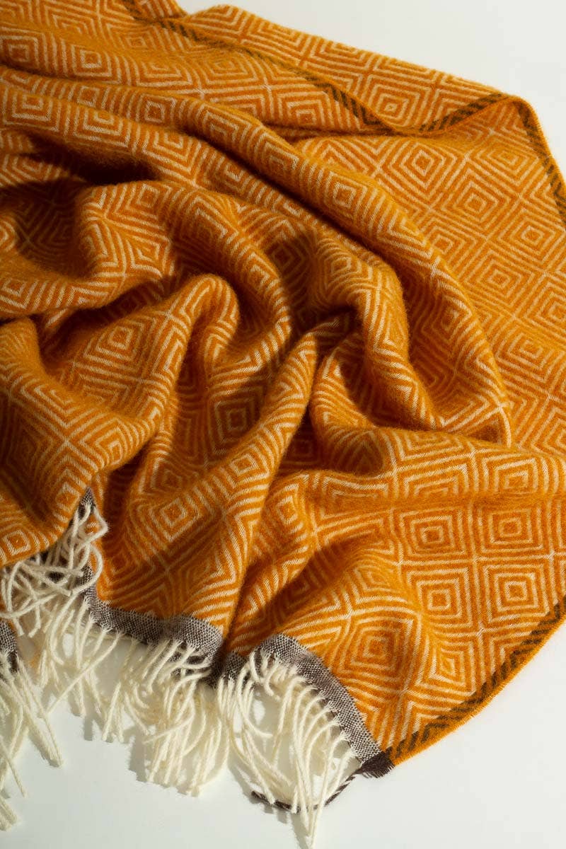 Warmgele wollen deken nonchalant gedrapeerd met zichtbare wolstructuur