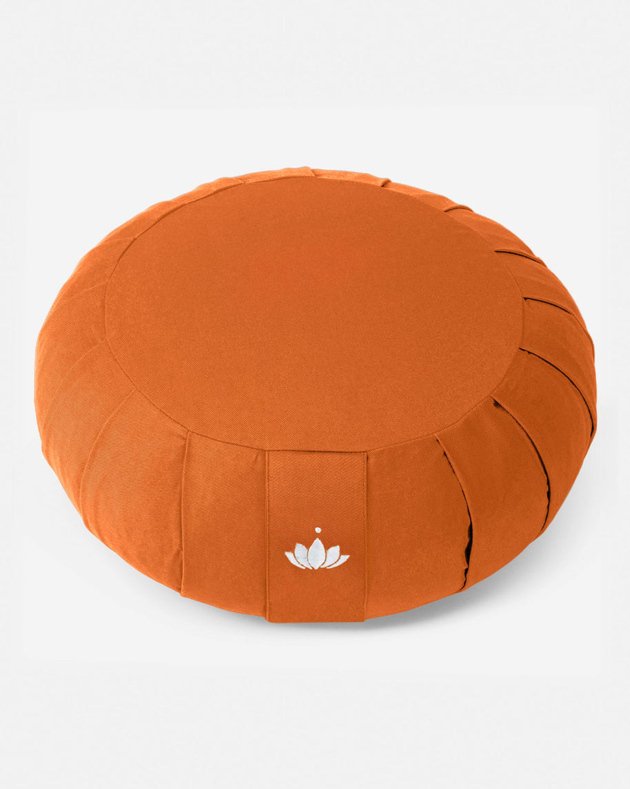 Oranje Zafu meditatiekussen van bovenaf gefotografeerd