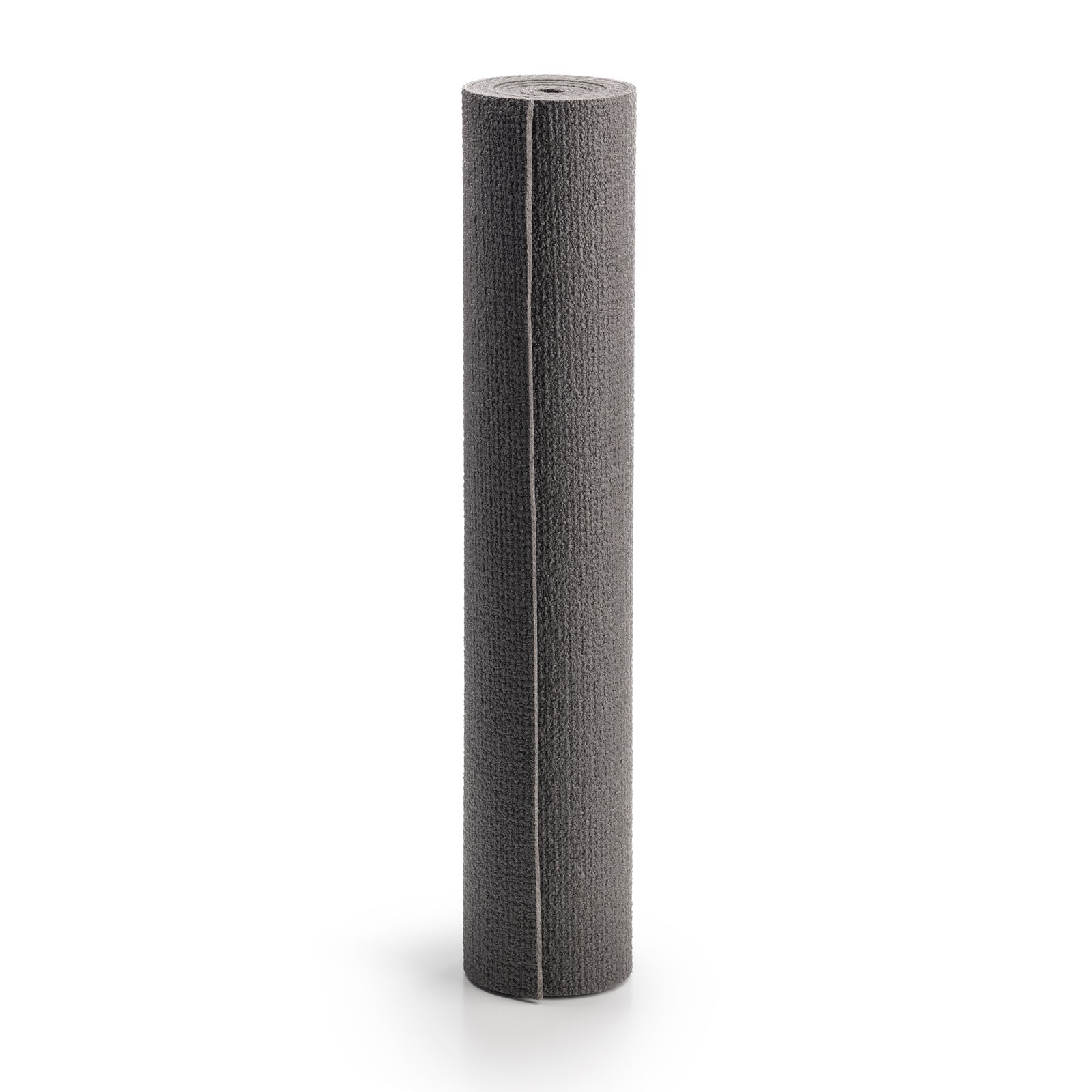 Grijze EXTRA travel yogamat uitgerold op een houten vloer in een lichte, rustige studio voor extra comfort en gronding.