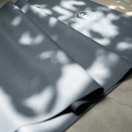 Detail van dunne Arise Travel Yogamat in natuurlijk licht